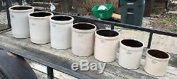Seven Blue Crown Stoneware Crocks Sizes 12, 10, 8, 6, 5, 3, and 2 gallons